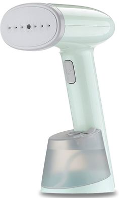 an electric hair dryer on top of a white base with a light green body