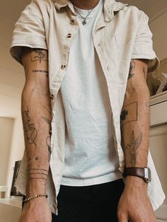 a man with many tattoos on his arms