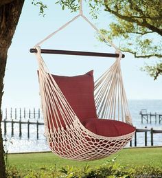 a blue hammock chair hanging from a tree