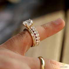 a woman's hand with a ring on it and a diamond in the middle