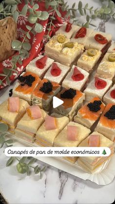 a table topped with lots of desserts on top of a white plate next to a basket