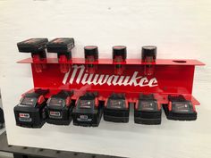 milwaukee tools hanging on the wall in a shop