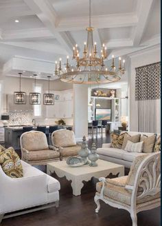 a living room filled with furniture and a chandelier