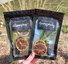 two bags of dried oranges in front of some grass and bushes with the words rosemary on them