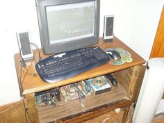 a computer monitor sitting on top of a wooden desk next to a keyboard and mouse