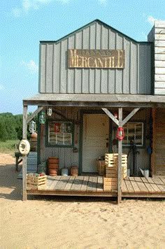 a small wooden building sitting on top of a sandy beach