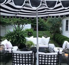 an outdoor patio with black and white furniture