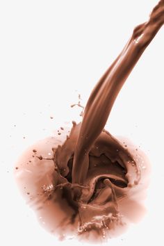 a chocolate splash is being poured onto the ground