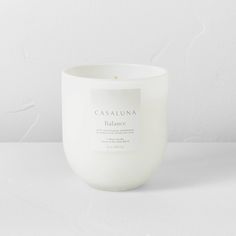 a white candle sitting on top of a table