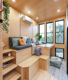 a living room filled with lots of furniture and wooden steps leading up to a window