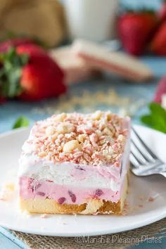 a piece of cake sitting on top of a white plate next to some strawberries