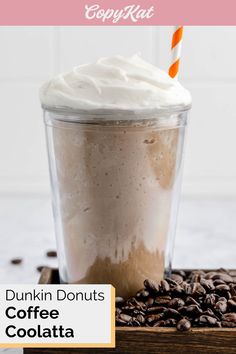 a cup of coffee with whipped cream on top and the words dunkin'donuts coffee