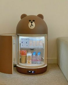 a brown bear shaped refrigerator with milk and yogurt in it's door