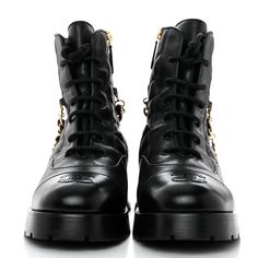 This is an authentic pair of CHANEL Shiny Calfskin Patent Quilted Chain Lace Up Combat Boots size 36 in Black. These chic combat boots are crafted of polished calfskin leather with quilted detailing on the side and a gold removable chain. They feature a 1.5-inch heel and 6.25-inch shaft, a sturdy black rubber base sole, and black laces. Lace Up Combat Boots, 5 Inch Heels, Black Laces, Black Rubber, Combat Boots, Calf Skin, Chanel, Lace Up, Thing 1