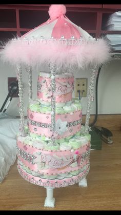 a pink and white wedding cake on top of a table