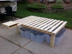 a bench made out of pallets and plastic containers