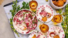 a table topped with plates and bowls filled with food