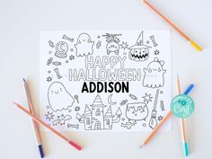 halloween coloring pages with markers and pencils next to them on a white surface, which reads happy halloween madison