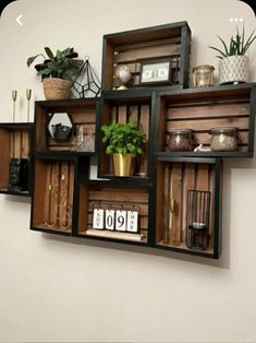 an arrangement of shelves with plants and other items on top of them, hanging from the wall