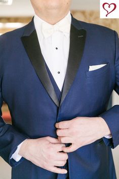 a man in a blue tuxedo with his hands on his chest and the words i love you written above him