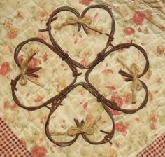 four heart shaped iron work on a quilt