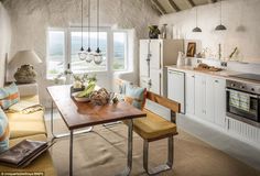 a kitchen with a table and chairs in it