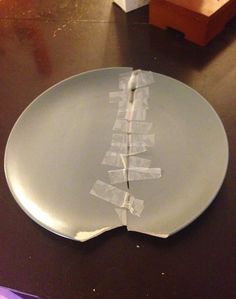 a white plate with torn up pieces of paper on it