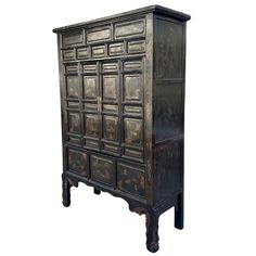 an old wooden cabinet with many drawers on the top and bottom, all painted black