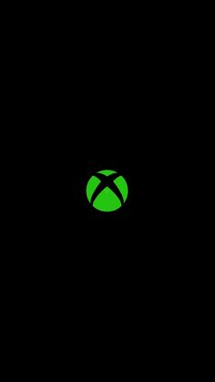 an image of the xbox logo on a black background with green light in the middle