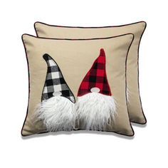 a decorative pillow with two gnomes on it