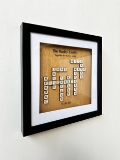 a framed crossword puzzle is hanging on the wall