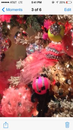 the christmas tree is decorated with pink and gold ornaments