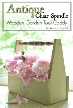 a wooden garden tool caddy with pink flowers in it and the title antique chair spindle