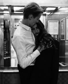 a man and woman embracing each other in an elevator