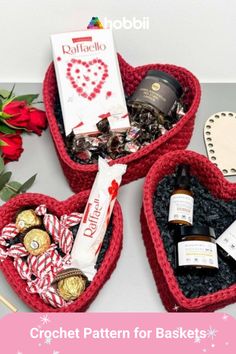 three heart shaped baskets filled with chocolates, candy and other holiday treats for valentine's day