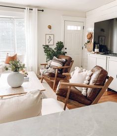 a living room filled with furniture and a flat screen tv