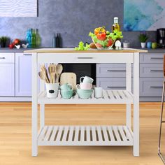 a kitchen island with pots and pans on it in the middle of a wooden floor