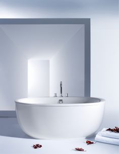 a white bath tub sitting inside of a bathroom