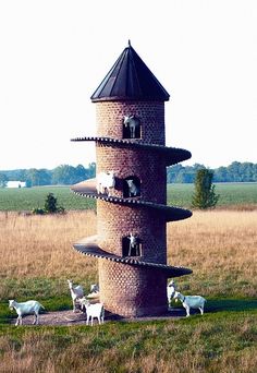 a tower that has animals on it in front of the words, if i had goats they'd totally have a goat castle