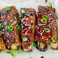 ribs covered in bbq sauce and garnished with green onions