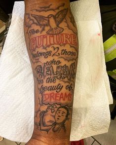 a person with a tattoo on their leg that says the future belongs to those who dream in beauty and dreams