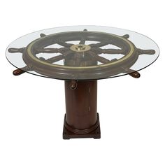 a glass and wood table with wheels on it