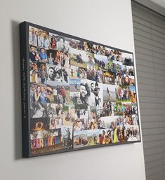 a large group of photos hanging on the wall above a door with shutters in front of it