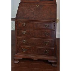 an old fashioned wooden desk with drawers