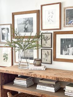 a wooden table topped with books and pictures