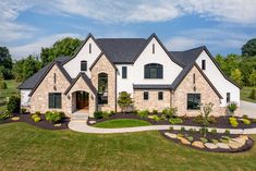 a large house with lots of windows and landscaping