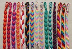 there are many different colored braids on the table and one has an arrow in it