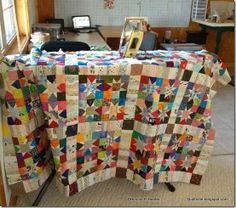 a quilted table cloth is on top of a sewing machine in an old room