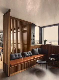 a living room filled with furniture next to a window covered in wooden slat walls