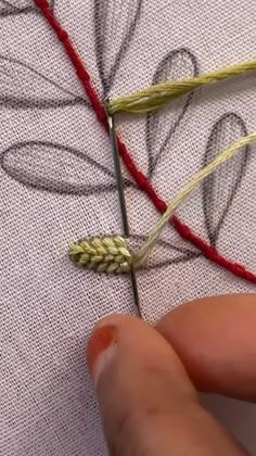 someone is stitching something on a piece of fabric